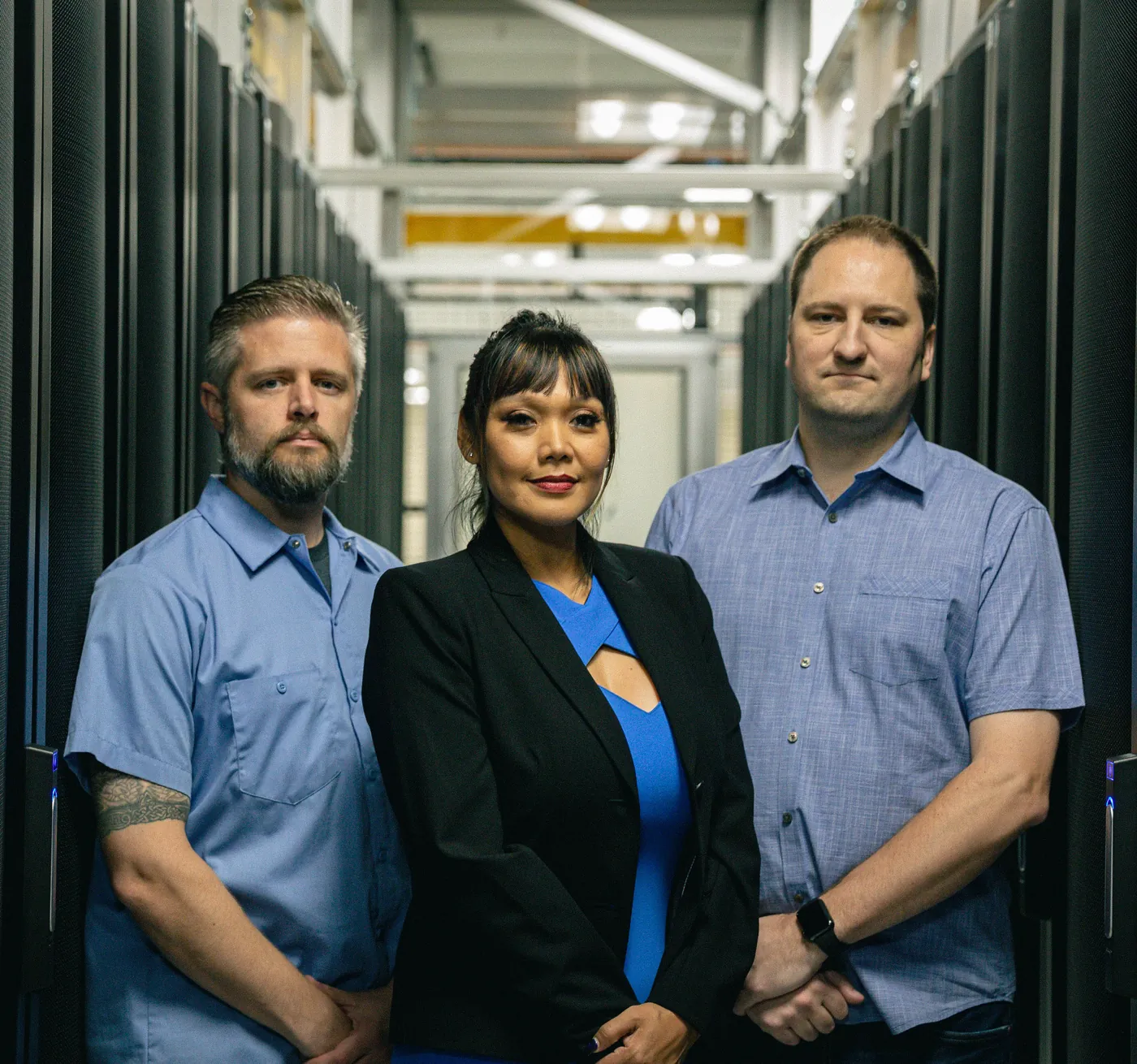 The Opus Interactive leadership team standing in a data center cold aisle.