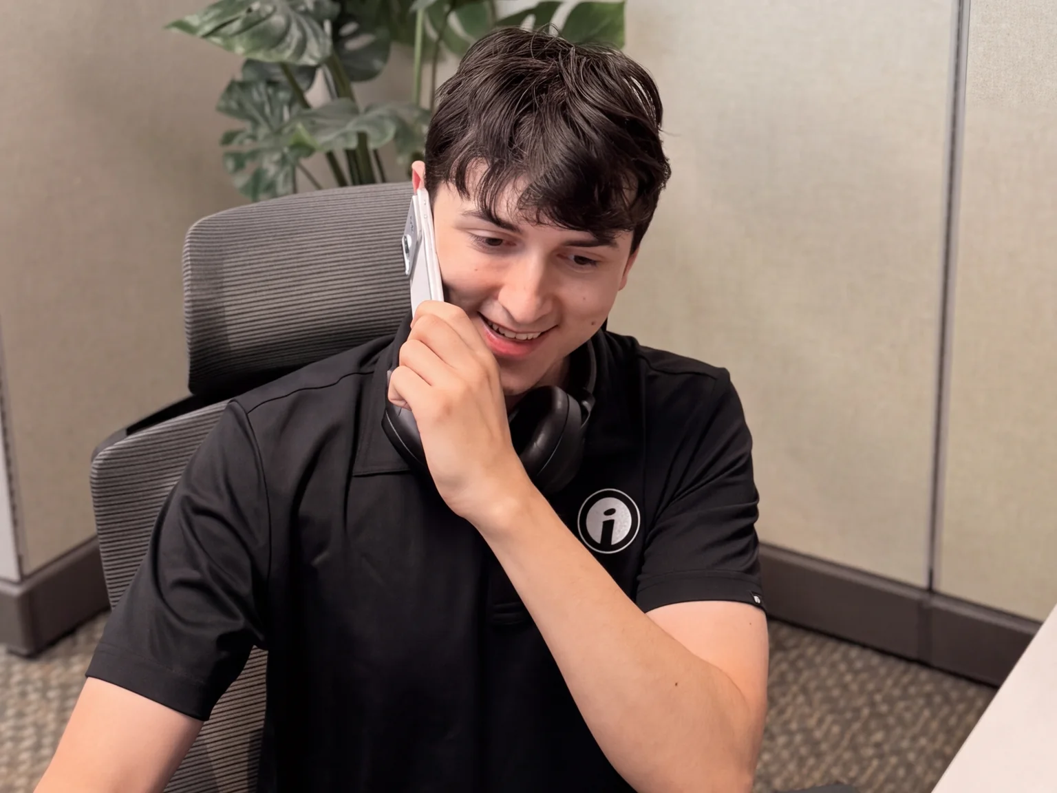 An Opus Interactive support engineer on a headset call at their desk.