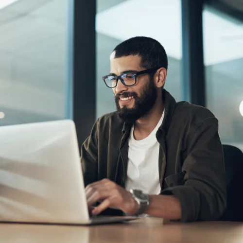 Man typing on laptop with Opus Interactives secure cloud technology.